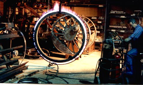 A new tire is sweated onto the wheel with a fire ring.  Photo by SLSTA Crewman Bob Buschart.  All rights reserved.