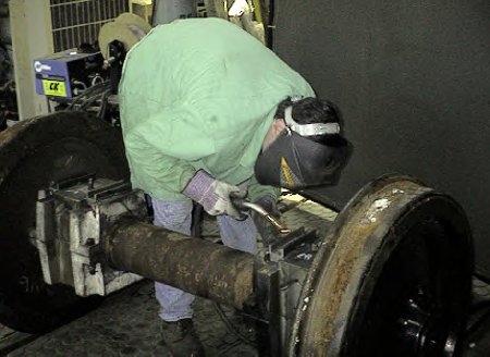 Shims are welded to the pilot truck journal box.